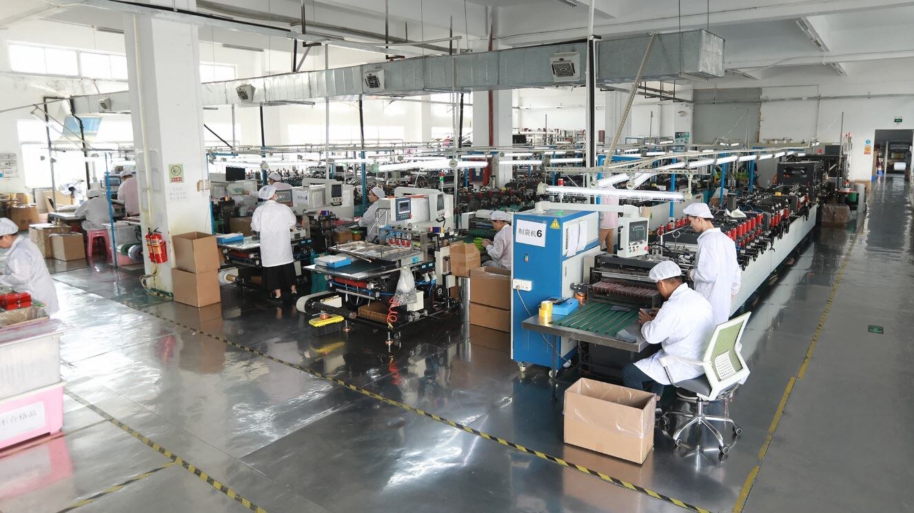 Bag-making hall at the Sayru plant in Shenzhen, China, with pouch-making machines running along the line