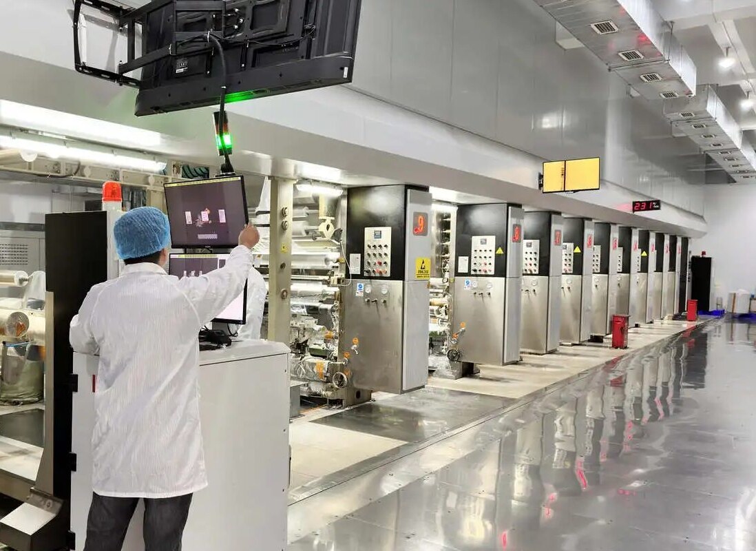 Operator at the console of a gravure printing line in the Sayru press hall, Shenzhen
